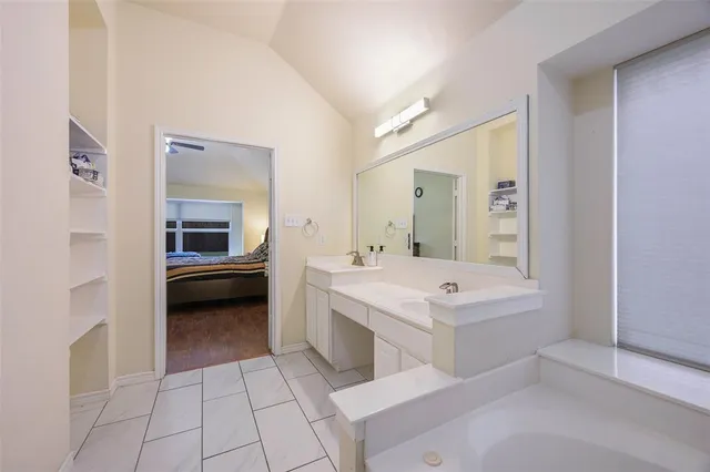 a spacious bathroom with a sink a mirror and a bathtub