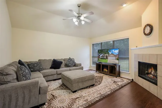 a living room with furniture a fireplace and a flat screen tv
