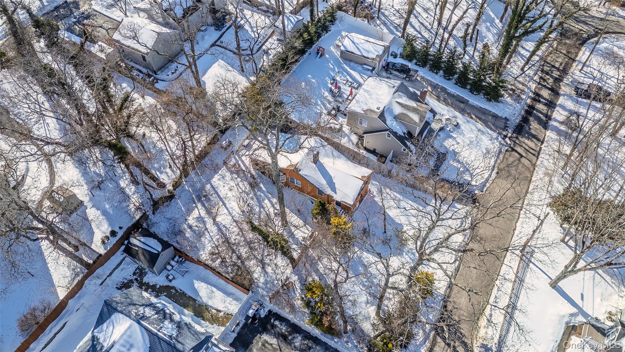 40 Hawthorne Road Rocky Point, NY 11778 - Photo 10 of 19 a backyard of a building with large trees