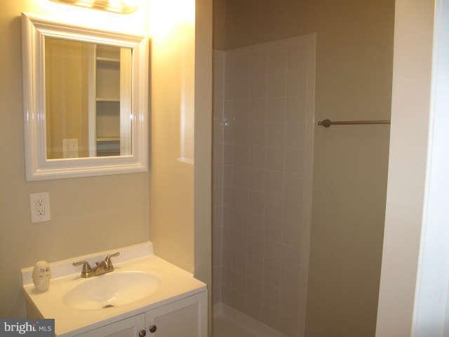 11034 Saffold Way Reston, VA 20190 - Photo 14 of 18 a bathroom with a sink and a mirror
