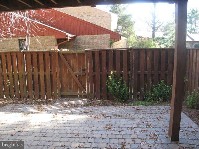 11034 Saffold Way Reston, VA 20190 - Photo 16 of 18 a view of a backyard with wooden fence