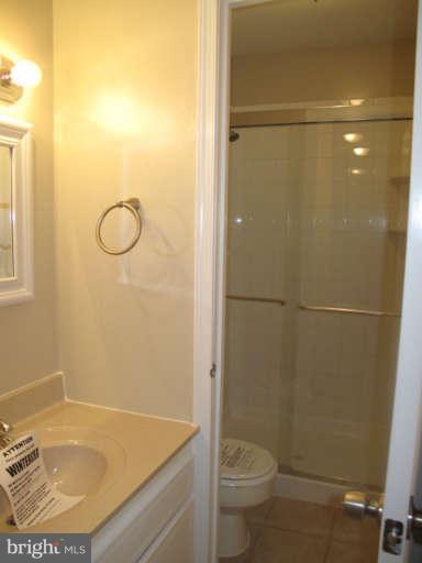 11034 Saffold Way Reston, VA 20190 - Photo 9 of 18 a bathroom with a sink and a shower