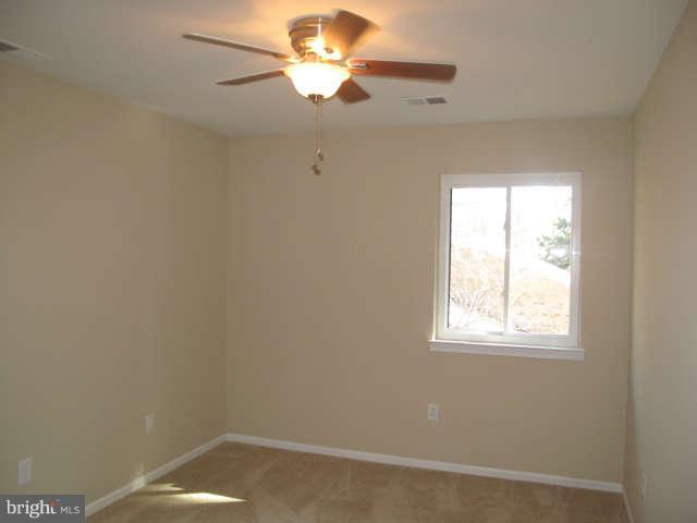 11034 Saffold Way Reston, VA 20190 - Photo 10 of 18 an empty room with a window and a fan
