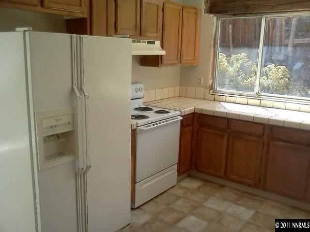 6870 Flower Street Reno, NV 89506 - Photo 4 of 13 a kitchen with a sink and a refrigerator