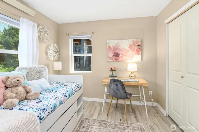 a living room with a bed furniture and a window