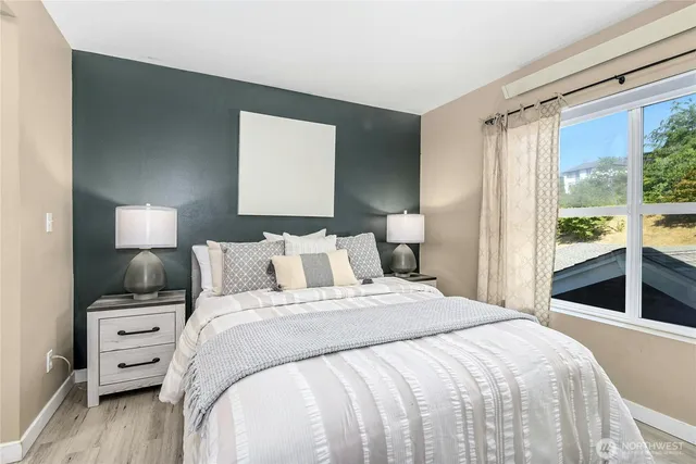 a bedroom with a bed and a large window