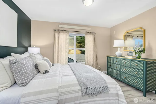 a bedroom with a large bed and a dresser