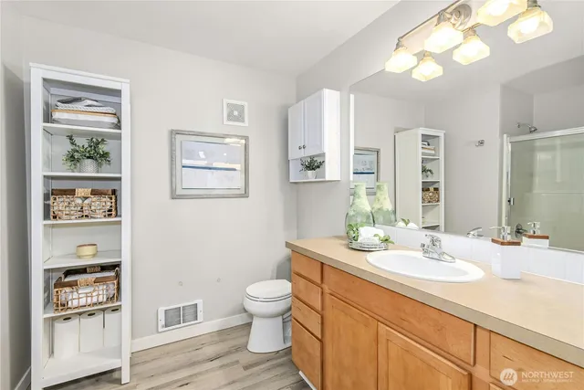 a bathroom with a toilet a sink and mirror