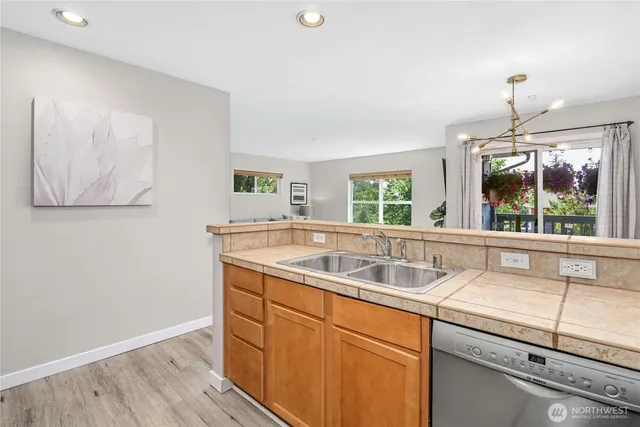 a kitchen with a sink and wooden floor