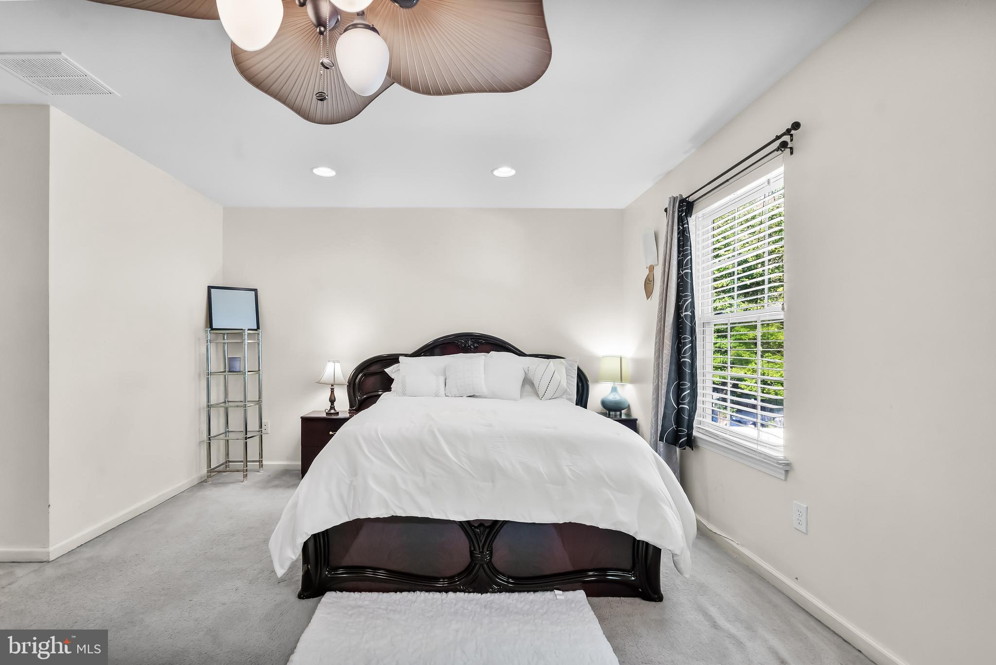 18 High Meadows Drive Sicklerville, NJ 08081 - Photo 18 of 25 a bedroom with a large bed and a chandelier