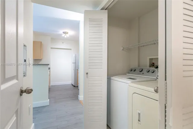 a view of a hallway with washer and dryer