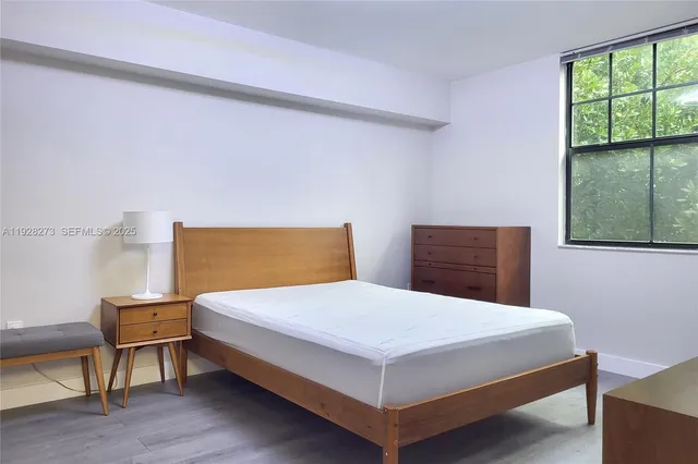 a bedroom with a bed and window