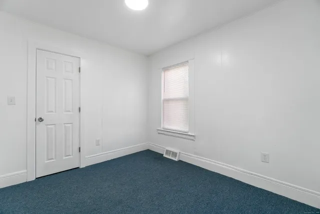 an empty room with a empty space and windows