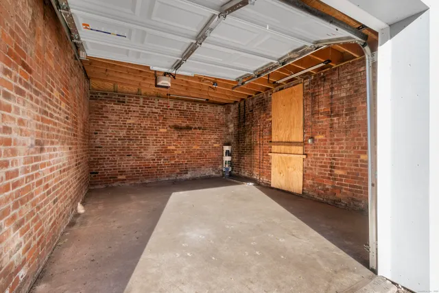 a view of backyard with brick wall and entryway