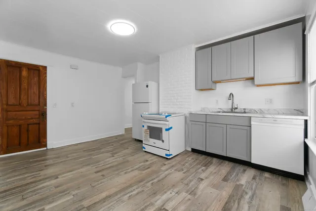 a kitchen with sink cabinets and wooden floor