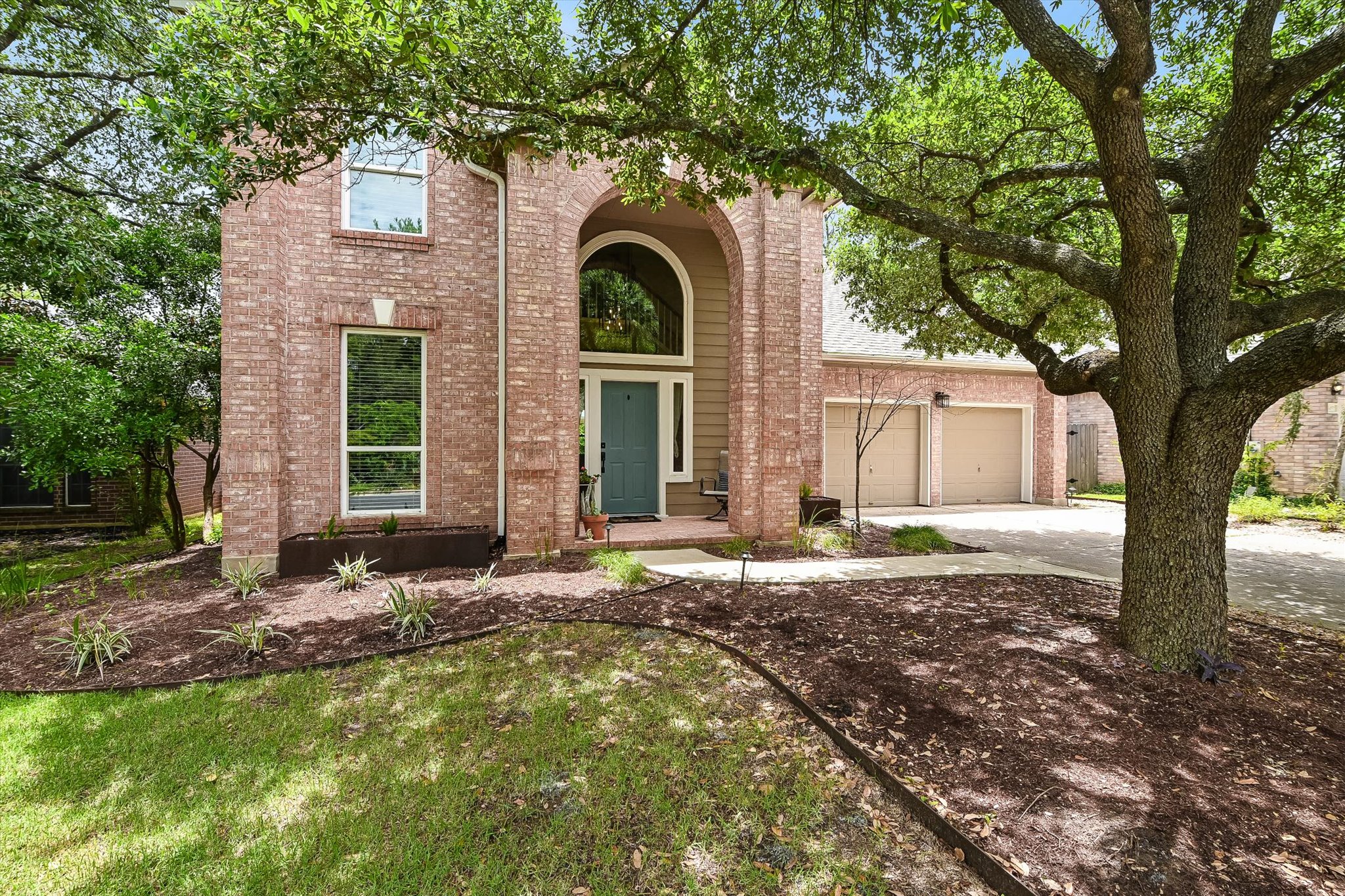 6456 Ruxton Lane Austin, TX 78749 - Photo 1 of 30 A classic brick exterior, framed by mature trees, presents a welcoming entrance and an attached garage.