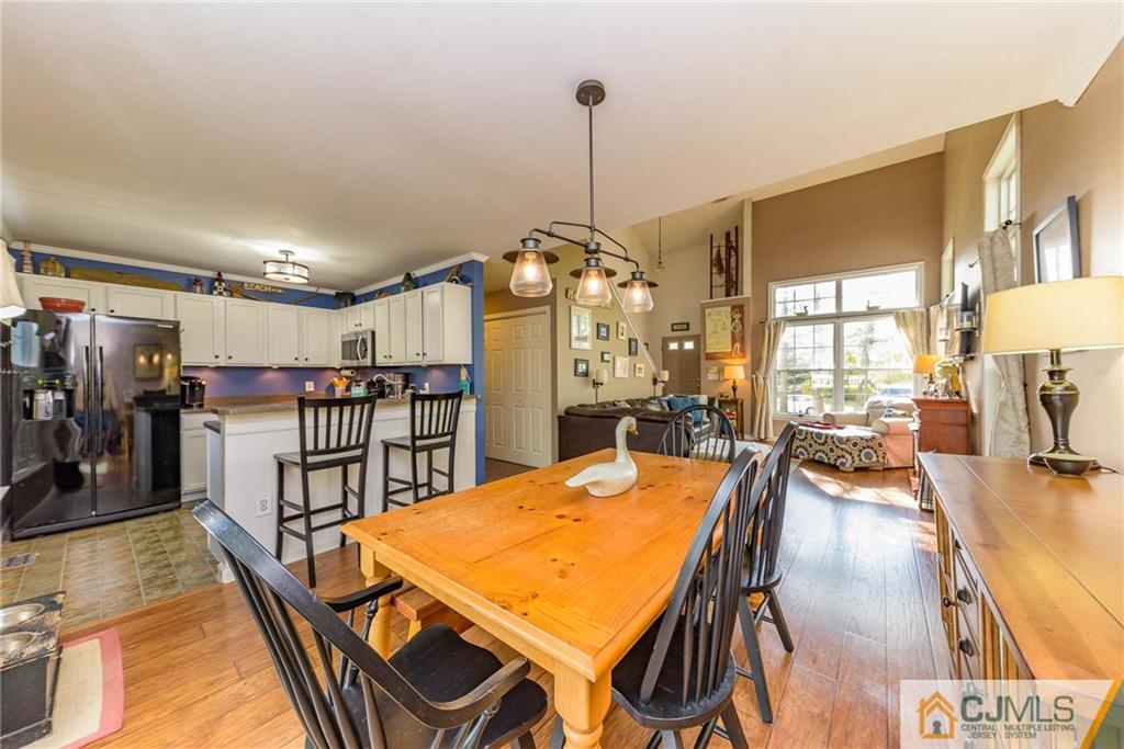 105 Quadrant Road Manahawkin, NJ 08050 - Photo 7 of 25 a dining room with furniture and a chandelier