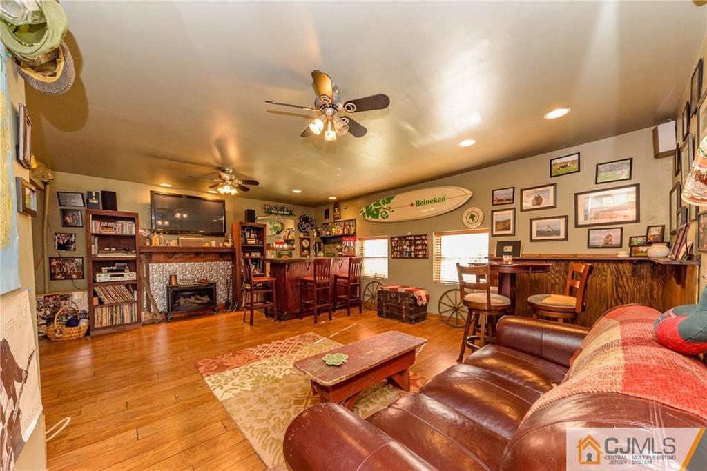 105 Quadrant Road Manahawkin, NJ 08050 - Photo 10 of 25 a living room with lots of chairs and a chandelier