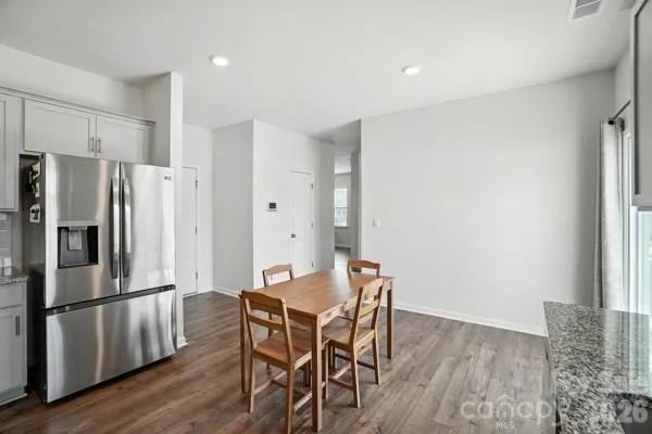 a kitchen with a table and refrigerator