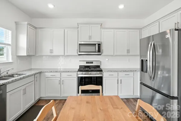 a kitchen with a stove and a refrigerator