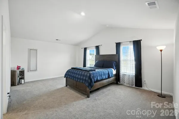 a bedroom with a bed and dresser