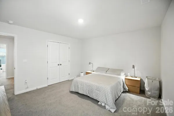 a bedroom with a bed and a table