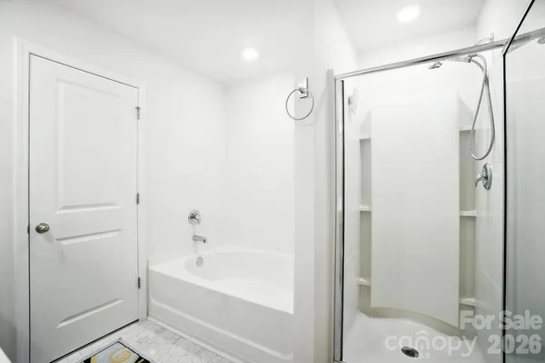 a bathroom with a shower and a bath tub