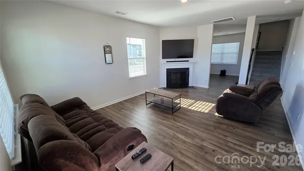 a living room with furniture flat screen tv and a fireplace