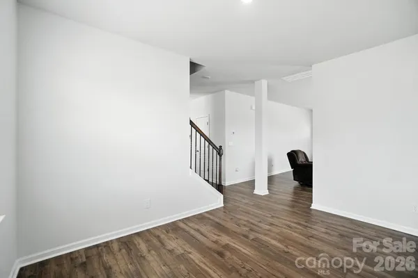 a view of a room with wooden floor and stairs