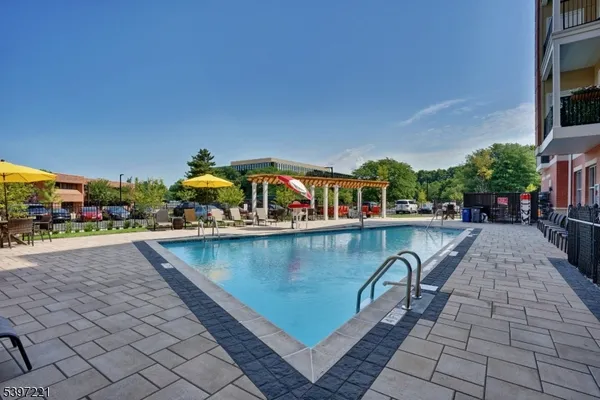 a view of a swimming pool with outdoor seating
