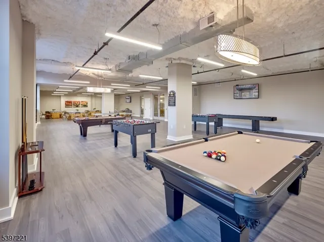 a view of a room with furniture and wooden floor