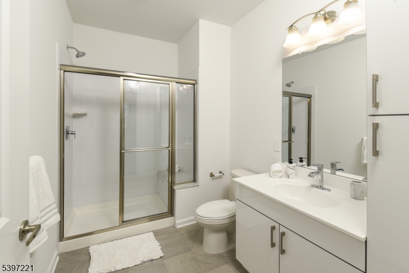 3 Ronson Road Woodbridge, NJ 08830 - Photo 2 of 17 a bathroom with a shower sink mirror and toilet