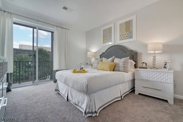 a spacious bedroom with a bed and a night stand