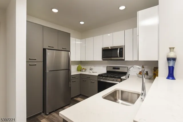 a kitchen with a refrigerator sink and microwave