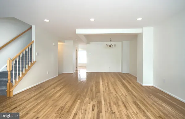 a view of a room with wooden floor and staircase