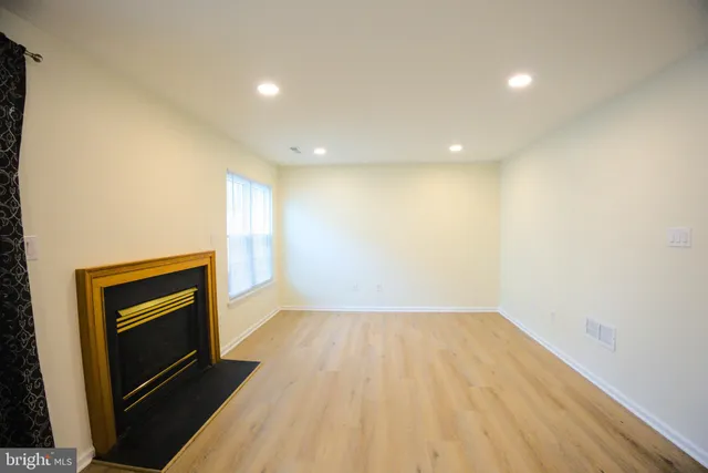 a view of an empty room and fire place