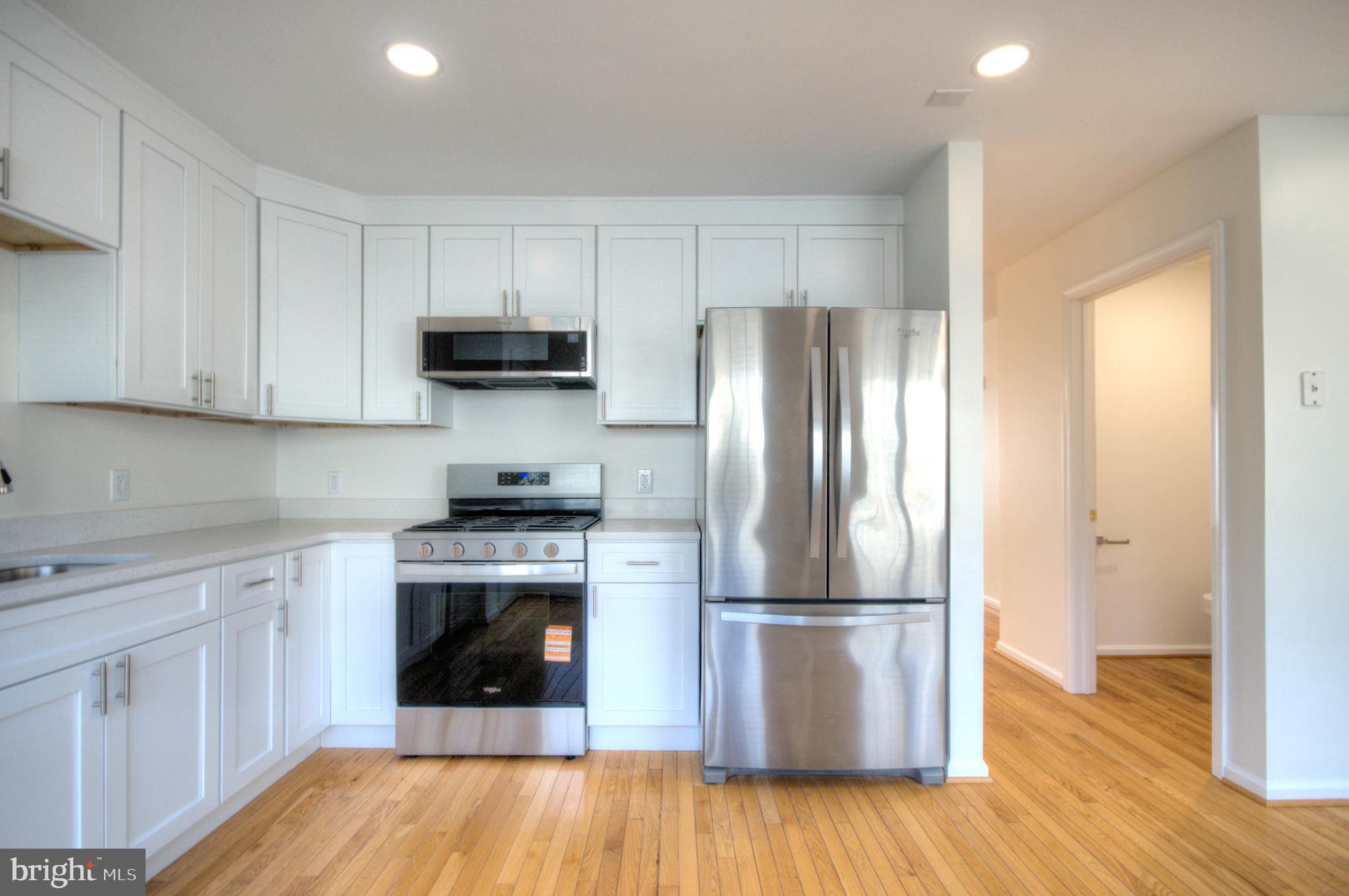 18 Alexandra Court Marlton, NJ 08053 - Photo 22 of 41 a kitchen with a refrigerator sink and wooden floor