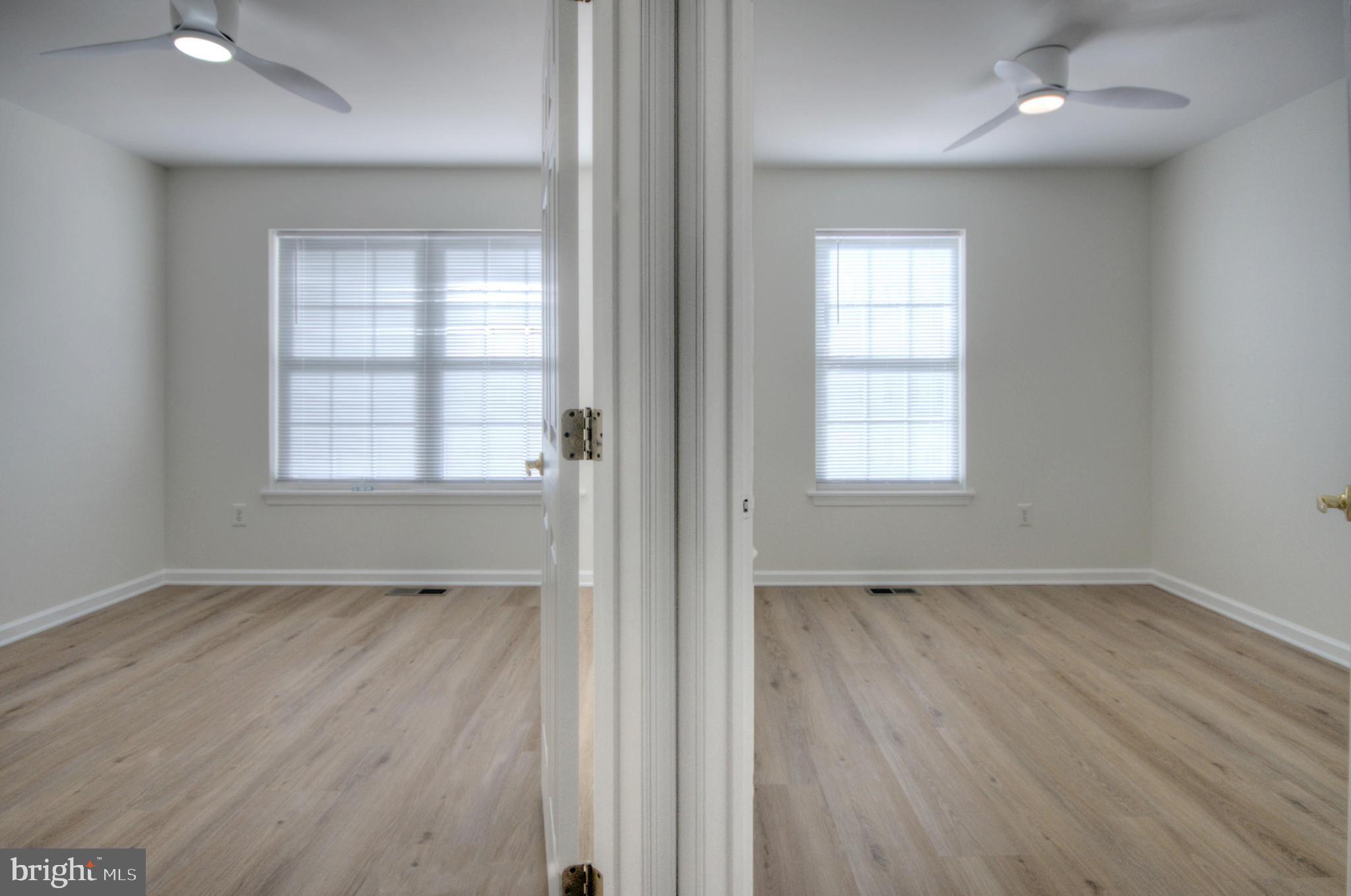 18 Alexandra Court Marlton, NJ 08053 - Photo 28 of 41 an empty room with wooden floor and windows