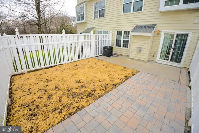 a view of a backyard with wooden fence