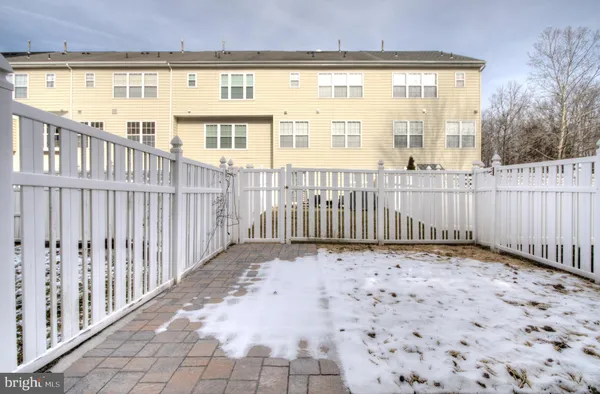 a view of a porch with wooden floor and fence