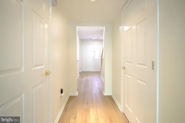 a view of a hallway with wooden floor