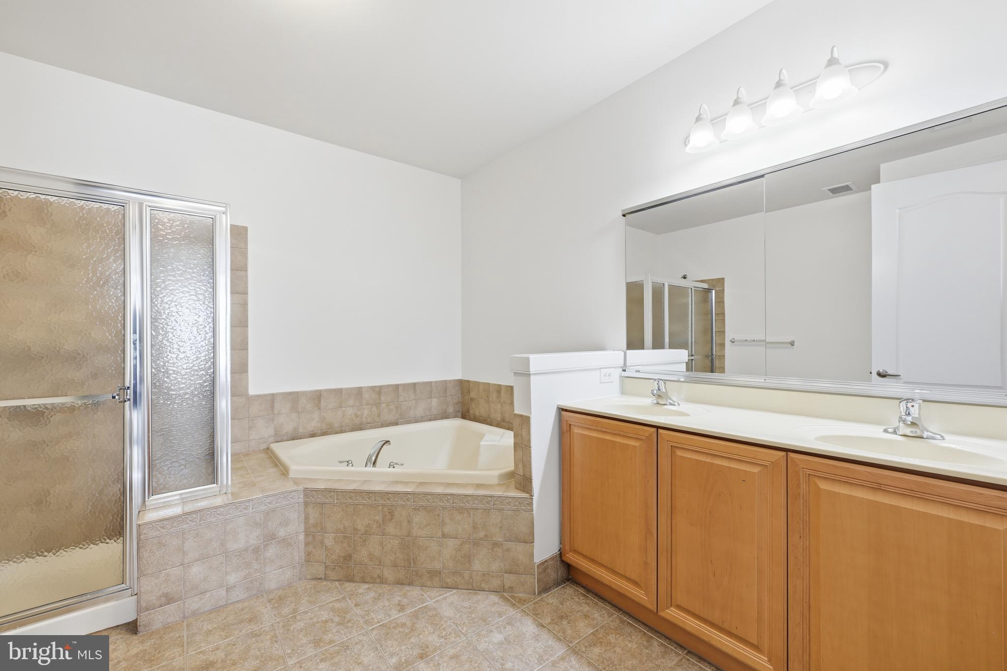 1333 Meridian Boulevard, Unit 1333 Warrington, PA 18976 - Photo 17 of 25 a bathroom with a tub sink shower and mirror