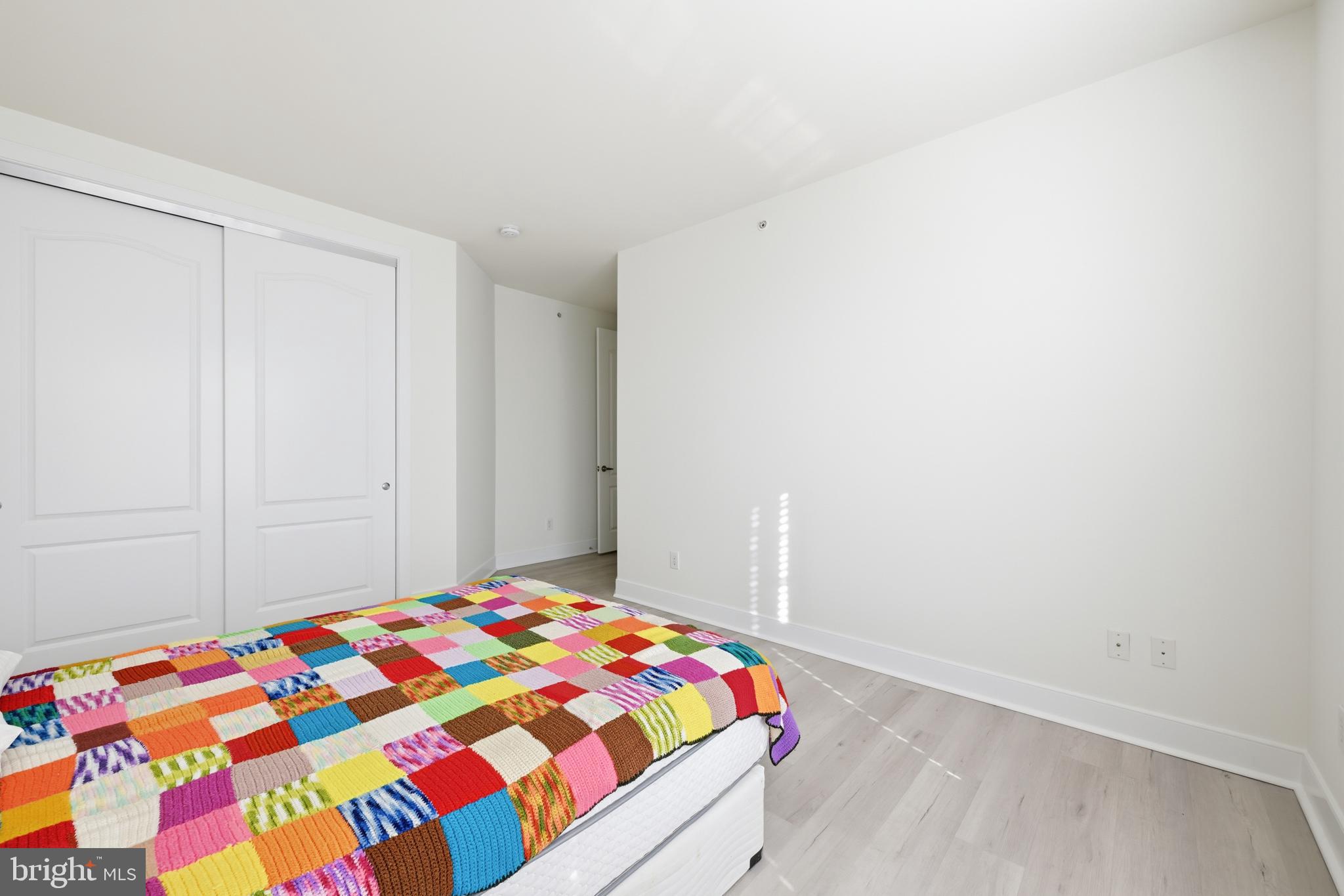 1333 Meridian Boulevard, Unit 1333 Warrington, PA 18976 - Photo 21 of 25 a bedroom with a bed and wooden floor