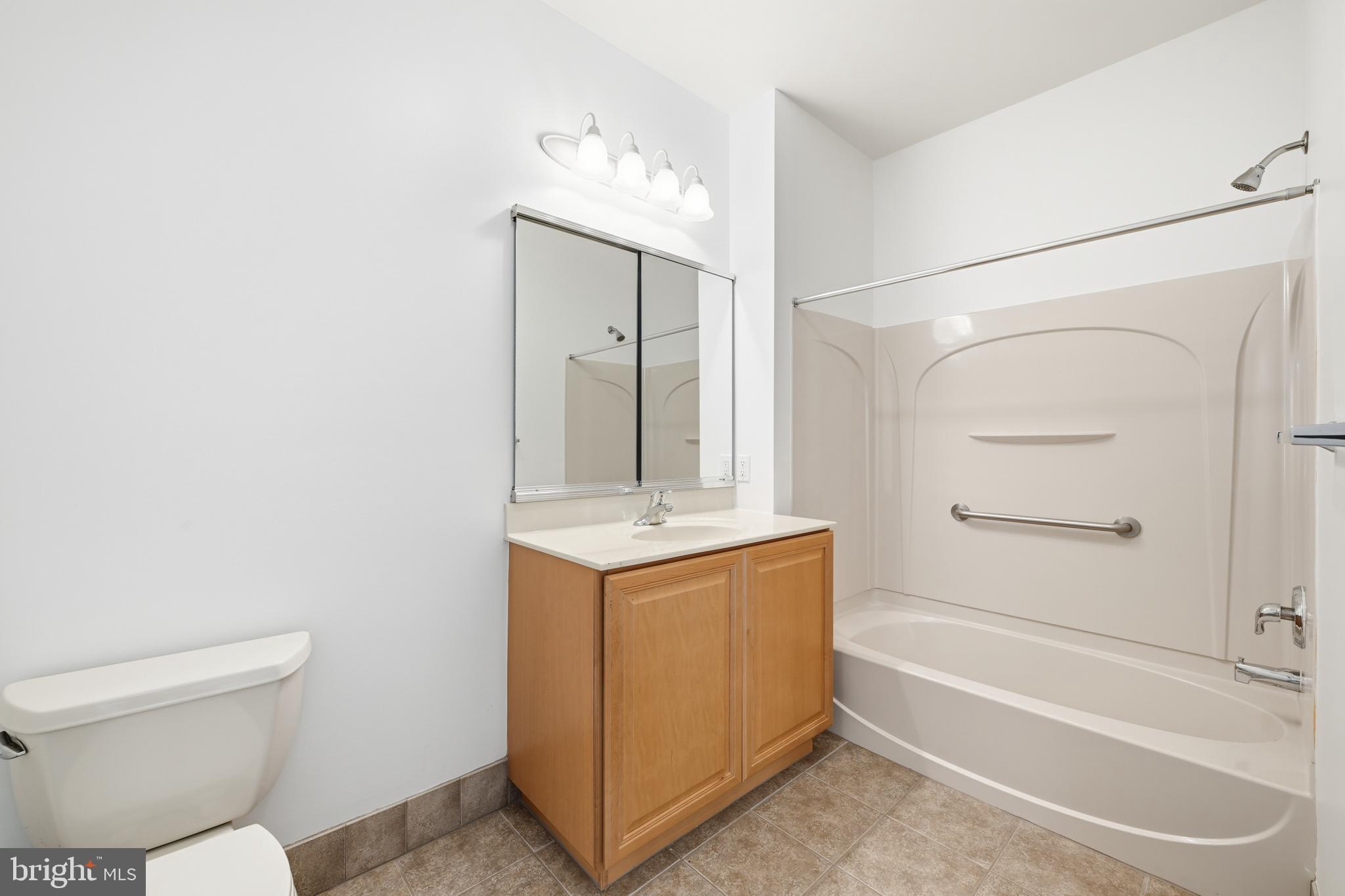 1333 Meridian Boulevard, Unit 1333 Warrington, PA 18976 - Photo 23 of 25 a bathroom with a granite countertop sink toilet and shower