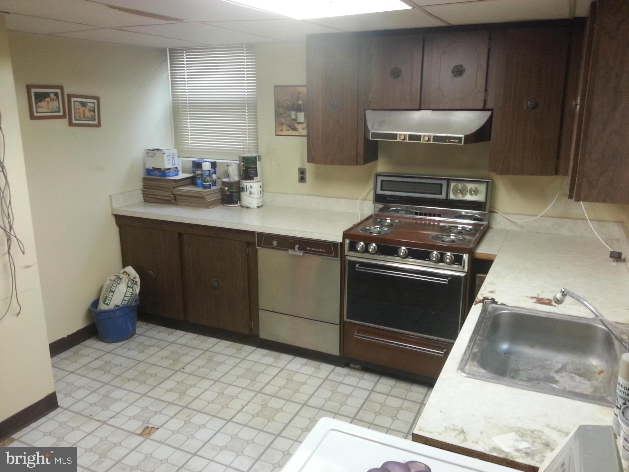 6707 Fordcrest Road Baltimore, MD 21237 - Photo 16 of 21 a kitchen with a stove and a cabinet