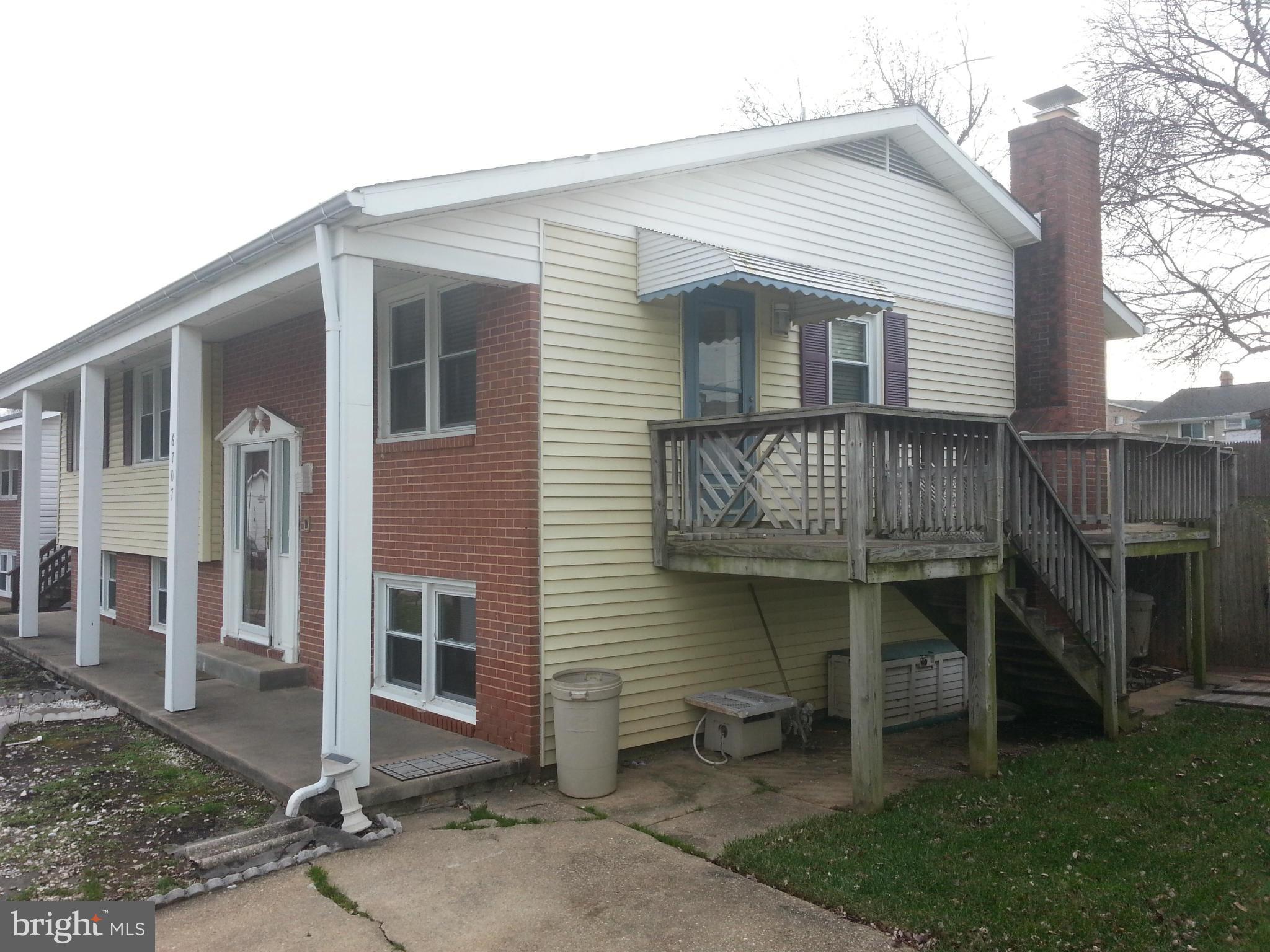 6707 Fordcrest Road Baltimore, MD 21237 - Photo 3 of 21 a front view of a house with a garden