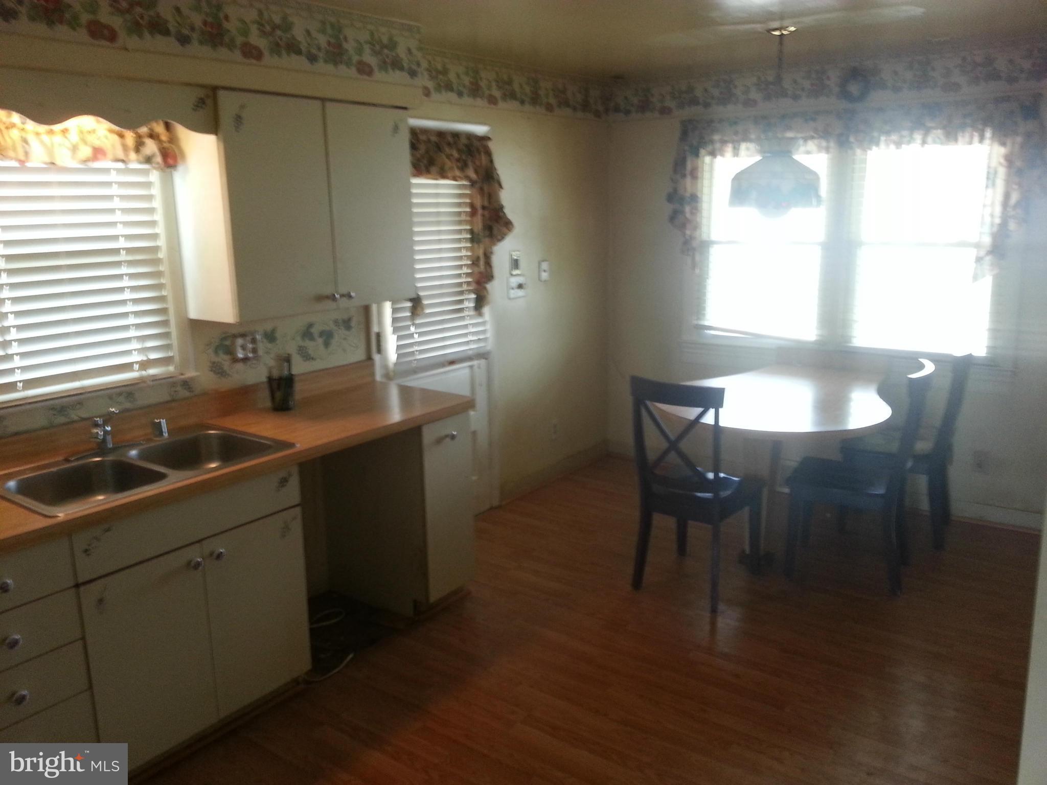 6707 Fordcrest Road Baltimore, MD 21237 - Photo 7 of 21 a kitchen with a sink cabinets and wooden floor