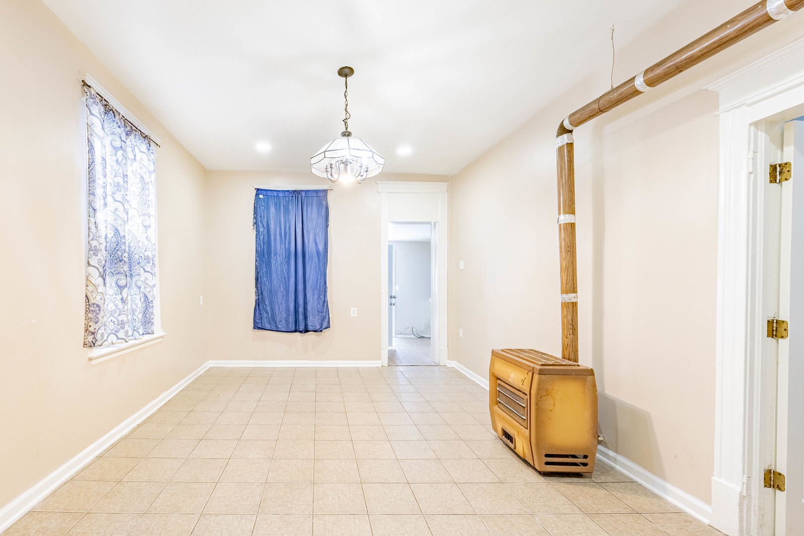 3022 South Homan Avenue Chicago, IL 60623 - Photo 18 of 29 a view of a hallway with a window and chandelier