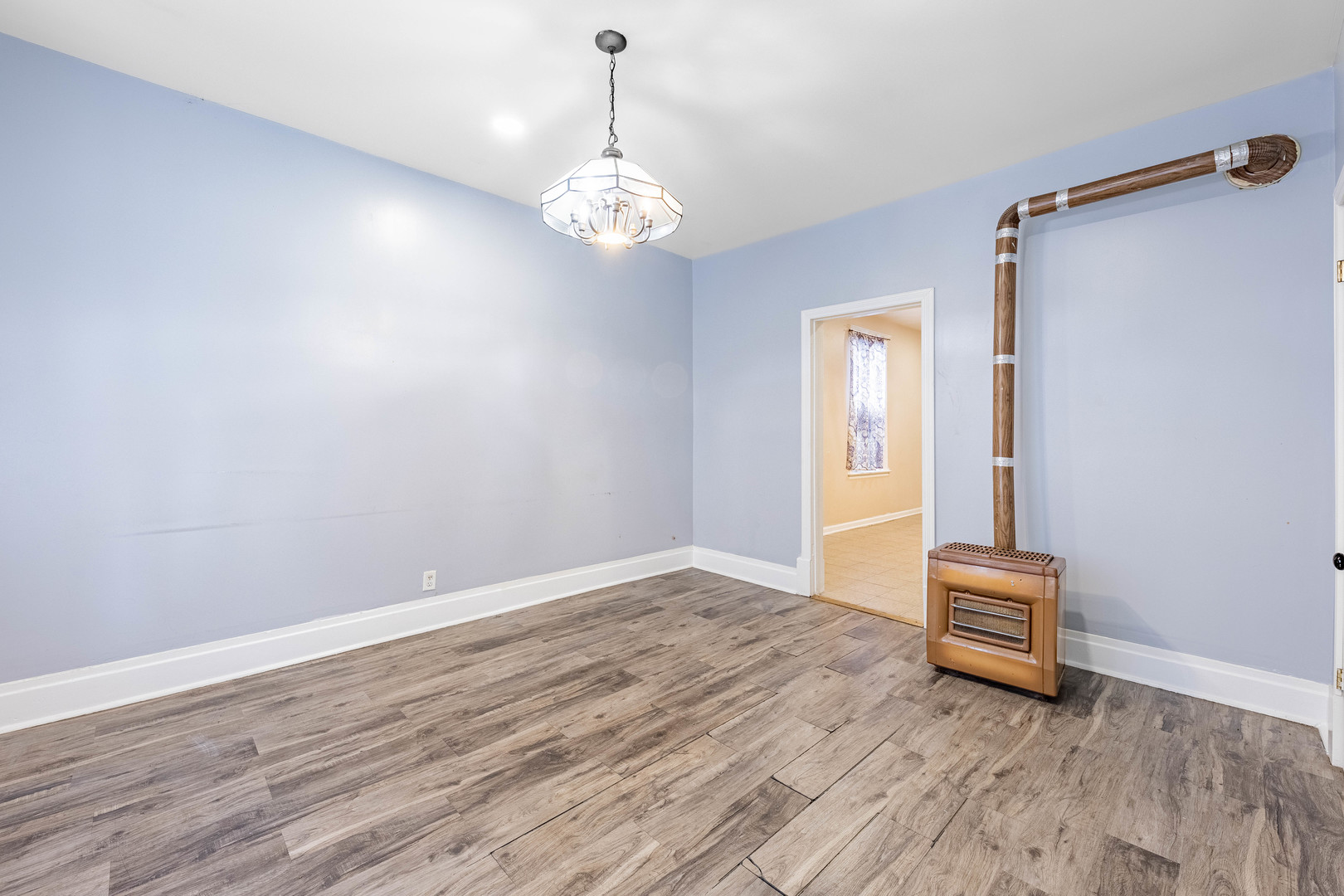 3022 South Homan Avenue Chicago, IL 60623 - Photo 19 of 29 a view of a room with wooden floor and staircase