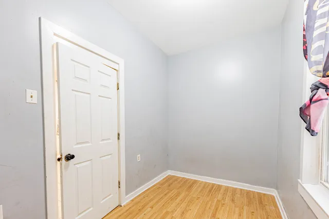 a view of a room with wooden floor and a bathroom